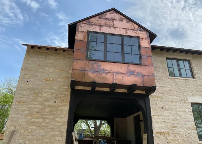 Copper metal panel facade on a stone building for Skylight Installation in Windham
